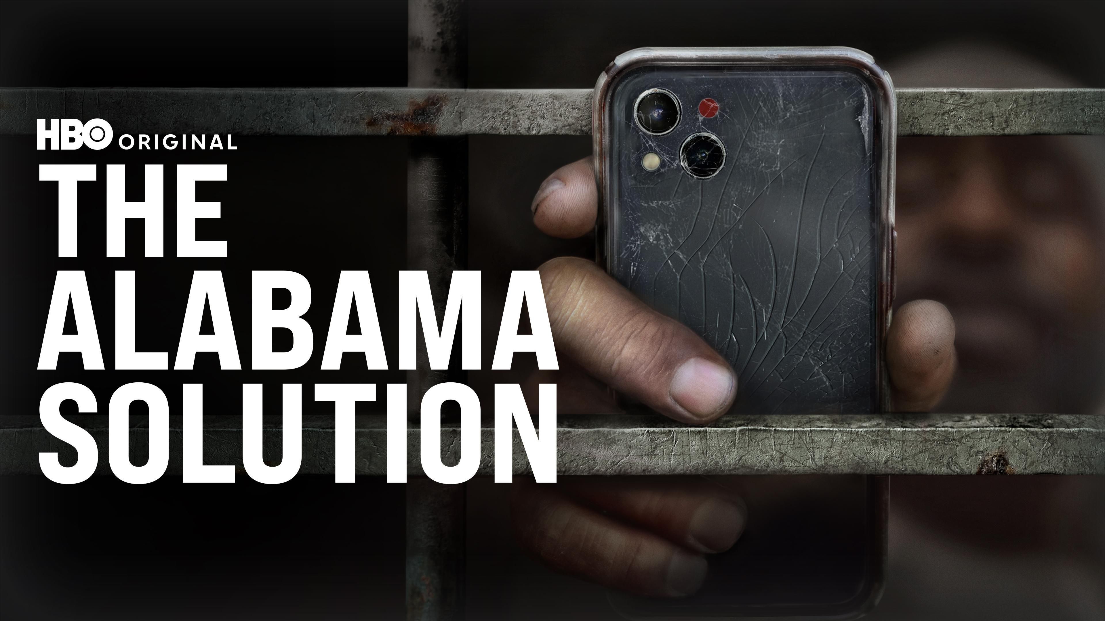 The Alabama Solution key art showing an Alabama prison facility behind fencing and guard towers
